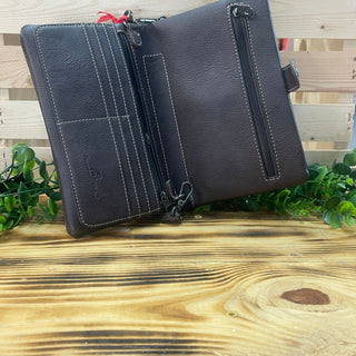 Open American Bling Cocoa Canyon Clutch, showing card slots, zipper pockets, and a key clip on a wooden surface.