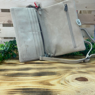 Open American Bling Desert Arrow Clutch in light tan, showing card slots, zipper pockets, and a shoulder strap.