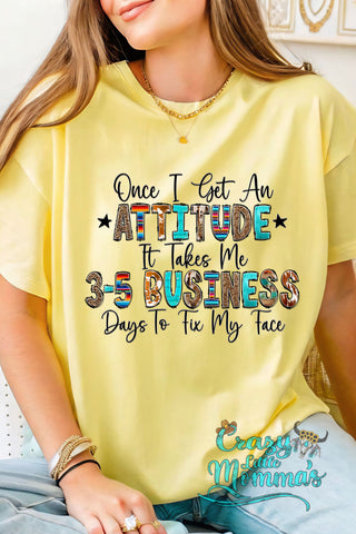 A woman wearing a yellow Attitude Tee with "Once I Get An ATTITUDE It Takes Me 3-5 BUSINESS Days To Fix My Face