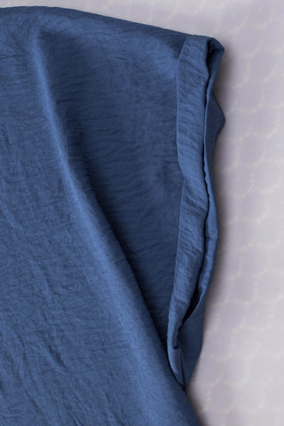 Close-up of the Canyon Horizon Blouse, showing the blue boho crinkle fabric and a rolled sleeve.