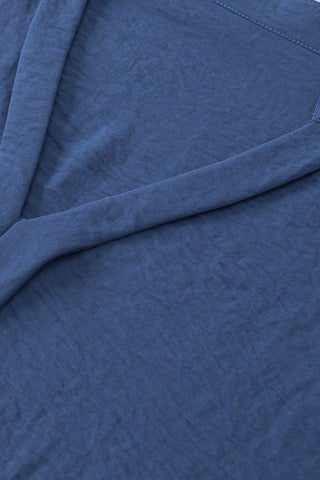 Close-up of the Canyon Horizon Blouse, showing the blue boho crinkle V-neck fabric texture and stitching.