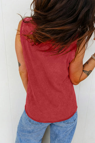 Back view of a woman wearing a Canyon Sunset Tank, a boho sunset red tank, with light wash jeans.