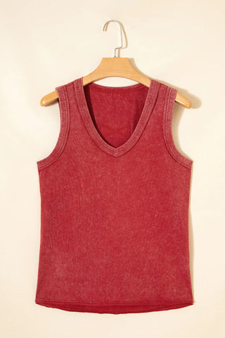 A red, ribbed Canyon Sunset Tank with a V-neck and distressed look, hanging on a wooden hanger.