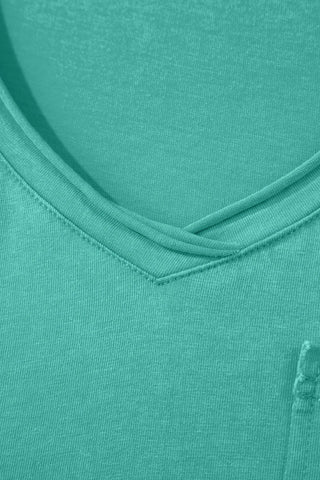 Close-up of a Canyon Teal Pocket Top, showing the V-neckline and fabric texture.