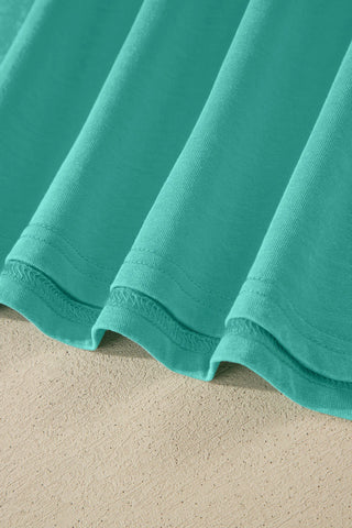 Close-up of the Canyon Teal Pocket Top fabric, showing the washed teal color and soft texture.