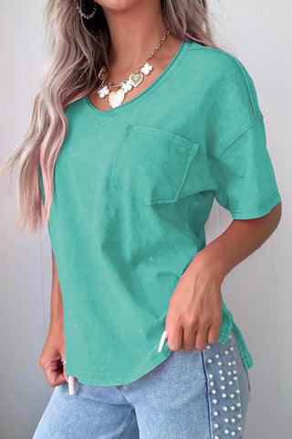 Woman wearing a Canyon Teal Pocket Top, a washed teal v-neck tee with a front pocket.