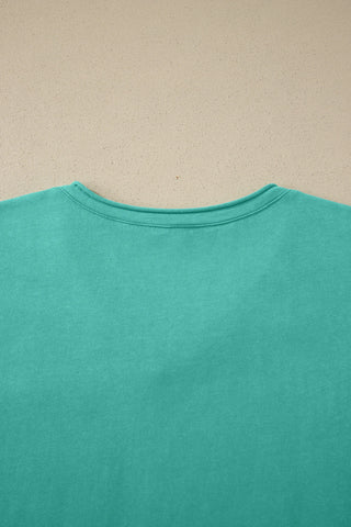 Close-up of the back of a Canyon Teal Pocket Top, showing the washed teal fabric and ribbed neckline.