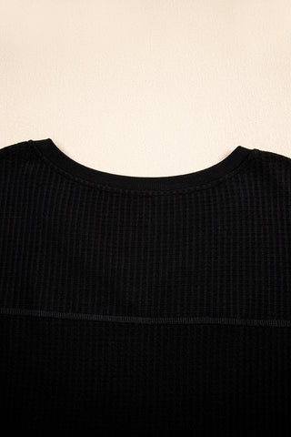 Close-up of the black Canyon Waffle Knit Top, showing the ribbed texture and crew neck.