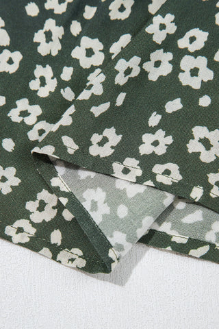 Close-up of the Cloverfield Mini Dress fabric, showing an olive green background with small white floral patterns.