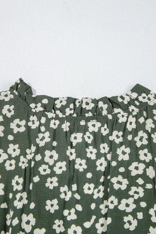 Close-up of the Cloverfield Mini Dress, showing the olive green fabric with a white floral pattern and ruffled neckline.