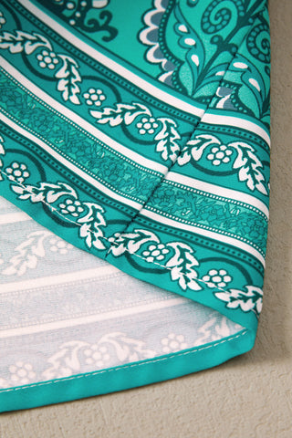 Close-up of the Country Breeze Maxi Dress fabric, showing a teal and white Bohemian floral pattern.