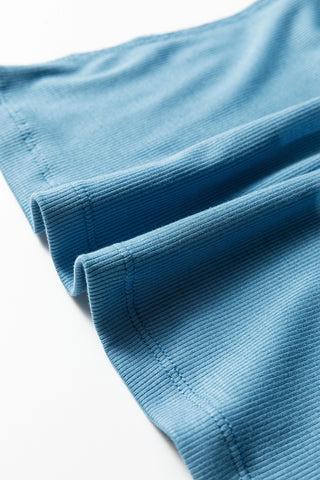 Close-up of the light blue Creekside Ribbed Top, showing the ribbed texture and stitching details.