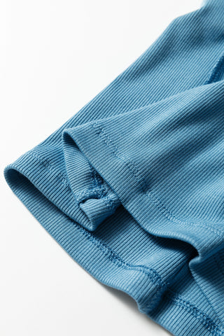 Close-up of the blue Creekside Ribbed Top, showing the ribbed fabric and stitching details.