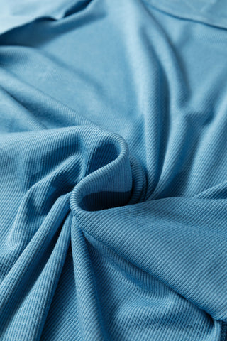 Close-up of the Creekside Ribbed Top, showing the light blue ribbed fabric with soft folds and texture.