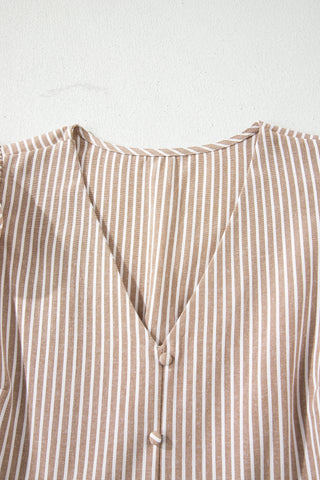 Close-up of the Daisy Lane Maxi Dress, showing its brown and white vertical stripes and button-down V-neck.