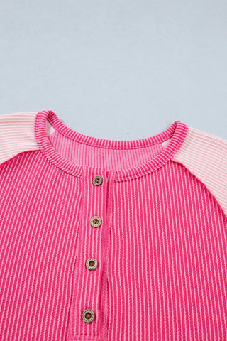 Close-up of a Desert Bloom Henley Top, showing the pink patchwork design and button placket.