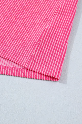 Close-up of the Desert Bloom Henley Top, showing its pink and light pink striped, textured fabric.