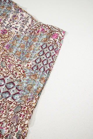 Close-up of the Desert Bloom Kimono, showcasing its intricate bohemian floral patchwork design in soft hues.