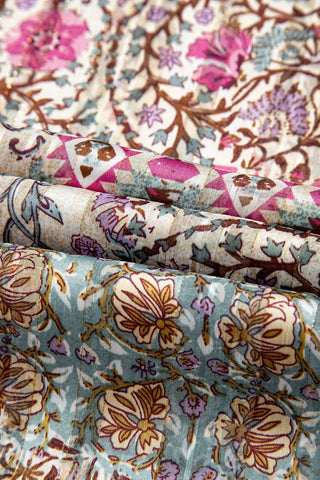 Close-up of the Desert Bloom Kimono fabric, showing a bohemian floral pattern in pink, purple, and teal.