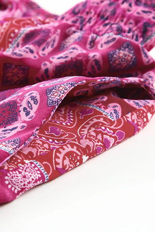 Close-up of the Desert Bloom Maxi Skirt, showing its vibrant pink and red bohemian patchwork pattern.