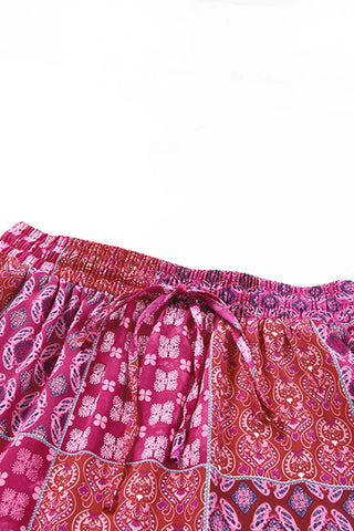 Close-up of a Desert Bloom Maxi Skirt with a bohemian patchwork design in shades of pink and red.