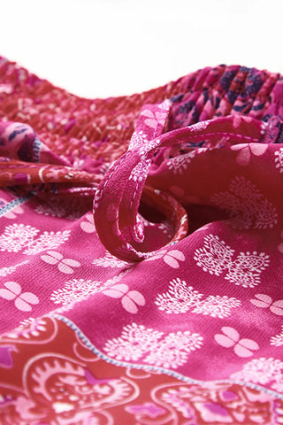 Close-up of a Desert Bloom Maxi Skirt, showing its vibrant pink and red bohemian patchwork print.