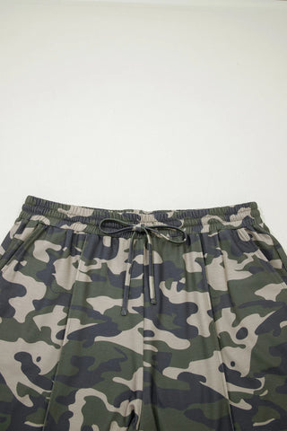 Close-up of Desert Trail Camo Shorts with an elastic waistband and drawstring, featuring green, tan, and black camo.