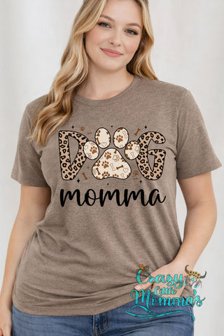 Woman in a brown "Dog Momma" tee with leopard print and paw print letters, smiling at the camera.