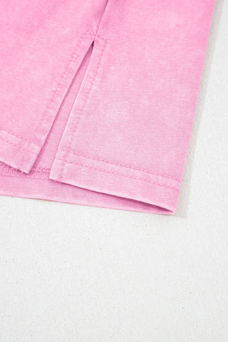 Close-up of the dusty rose pocket top, showing the acid wash fabric texture and a side slit detail.