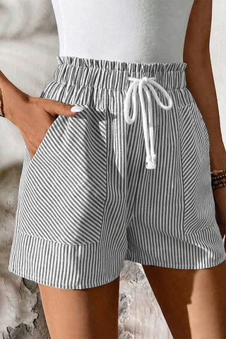 Close-up of Fresh Linen Stripe Shorts with a ruffled elastic waist, drawstring, and pockets.