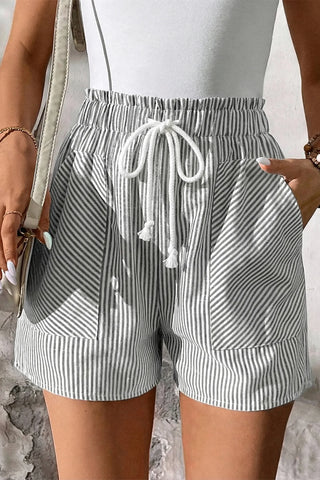 Close-up of Fresh Linen Stripe Shorts with a white drawstring, pockets, and a ruffled elastic waistband.