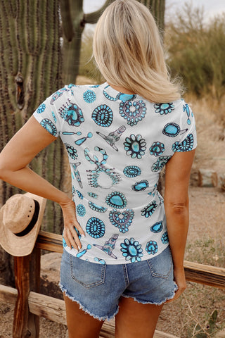 Back view of a blonde woman wearing a white Frontier Concho Tee with turquoise concho designs.
