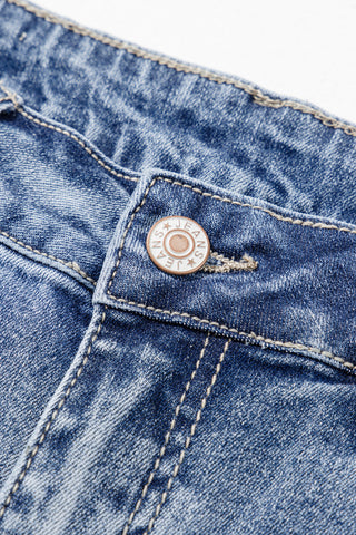 Close-up of the button and fly of Highway Honey Flare Jeans, showing distressed blue denim and stitching.