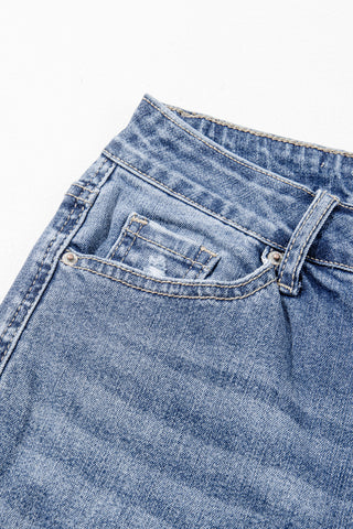 Close-up of the light wash Highway Honey Flare Jeans, showing a distressed front pocket and belt loops.