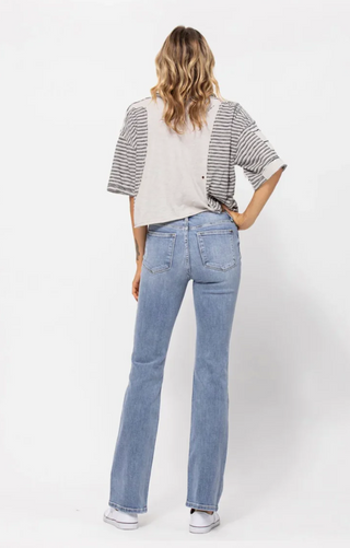 Back of model wearing Judy Blue Mid Rise Light Wash Bootcut Country Jeans