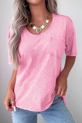 Model wearing a dusty rose acid wash V-neck top with a front pocket, paired with light wash jeans.