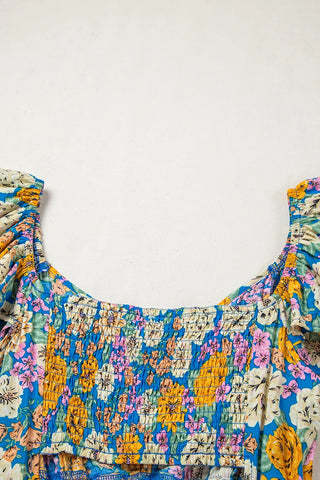 Close-up of the Canyon Bloom Jumpsuit, showing the floral smocked bodice and puff sleeves.