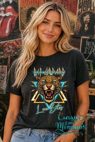 A woman models a dark gray "Love Bites" tee with a leopard head, "Def Leppard" text, and lightning bolts.