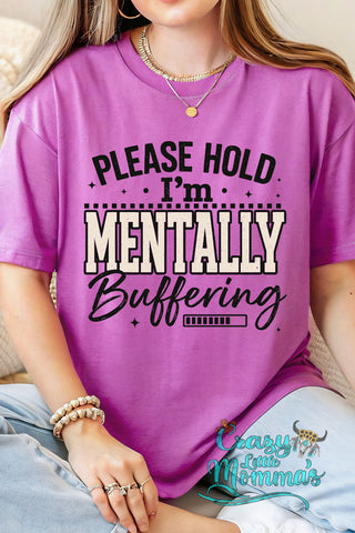 A woman wears a purple "Please Hold I'm Mentally Buffering" Western sarcasm tee with a loading bar graphic.