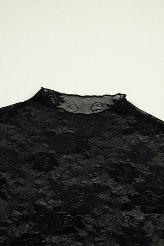 Close-up of a black Midnight Bloom Lace Top with a mock neck and delicate floral patterns.