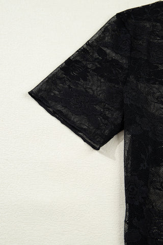 Close-up of the sheer black Midnight Bloom Lace Top, showcasing its delicate floral pattern and short sleeves.