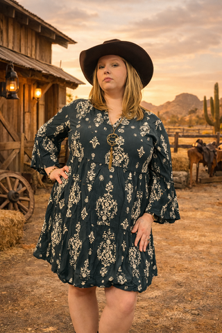 Woman in a Midnight Magnolia Dress, a dark green Western Boho dress with a cream floral pattern.