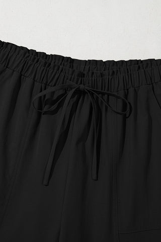 Close-up of the elastic waistband and drawstring tie on black Midnight Prairie Wide Pants.
