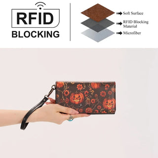 Hand holding a Montana West Pumpkin Floral Halloween Wallet with RFID blocking, featuring jack-o'-lanterns and flowers.