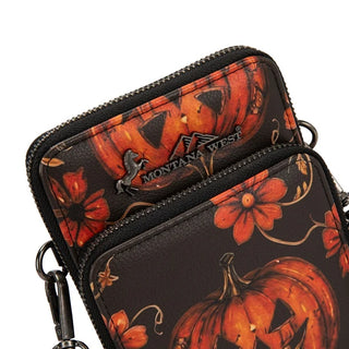 Close-up of a black Montana West crossbody phone wallet with a Halloween pumpkin and floral print.