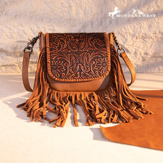 Brown Montana West crossbody purse with intricate floral tooling on the flap and long fringe detailing.