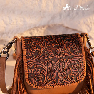 Close-up of a brown Montana West Tooled Leather Fringe Crossbody Purse with intricate floral tooling and fringe.