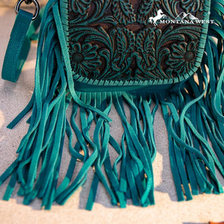 Close-up of a turquoise Montana West Tooled Leather Fringe Crossbody Purse with intricate floral tooling.