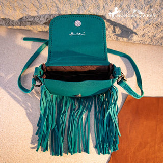 Open turquoise leather crossbody purse with fringe, showing interior pockets and magnetic snap closure.