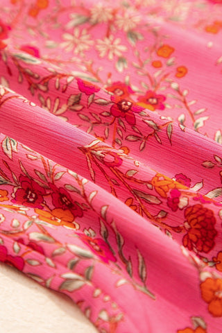 Close-up of the Morning Glory Blouse, showcasing its vibrant floral geometric pattern on pink fabric.